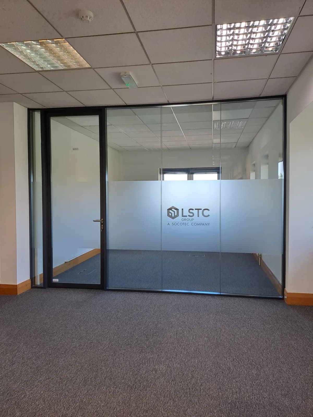 Completed glazed office front and framed door at Charlotte House in Derby