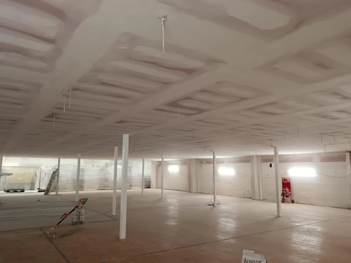 MF ceiling grid during tape and joint stage at Dunelm Glasgow, showing fire-rated Rockwool FirePro insulation before decoration