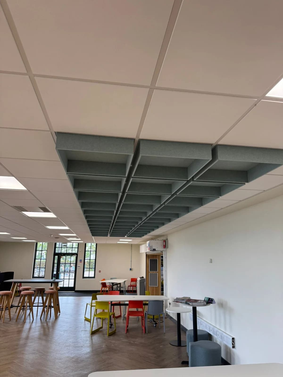 Completed hanging acoustic baffle feature beneath a white ceiling at Jubilee Campus