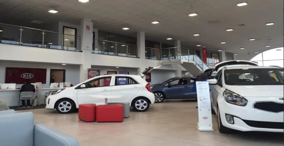 Zentia Dune exposed-grid ceiling detail in the Kia Burton-on-Trent showroom with sloped installation