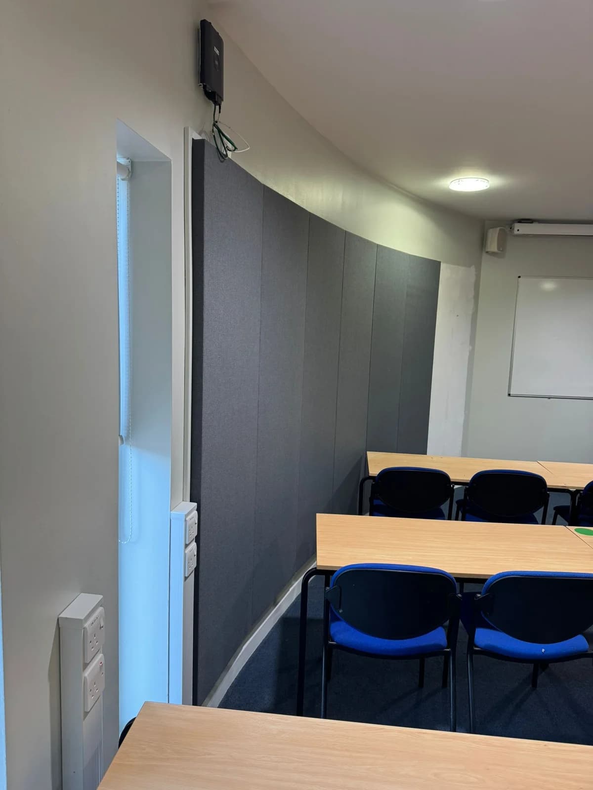 Dark acoustic panel finish beside a doorway at Portland Building